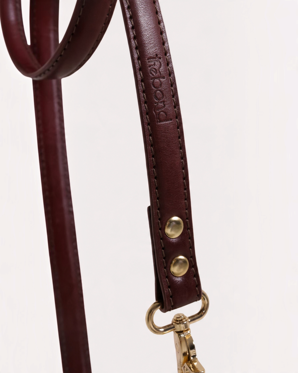 The bond vegetable tanned leather dog lead in deep brown with solid zinc hardware and hand-stitched detailing.